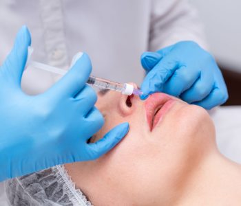 Lip,Augmentation.,Beautician,Injects,Hyaluronic,Acid,Into,The,Lips,Of